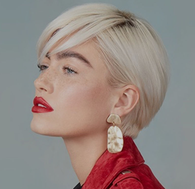 Woman in red top with short blonde hair